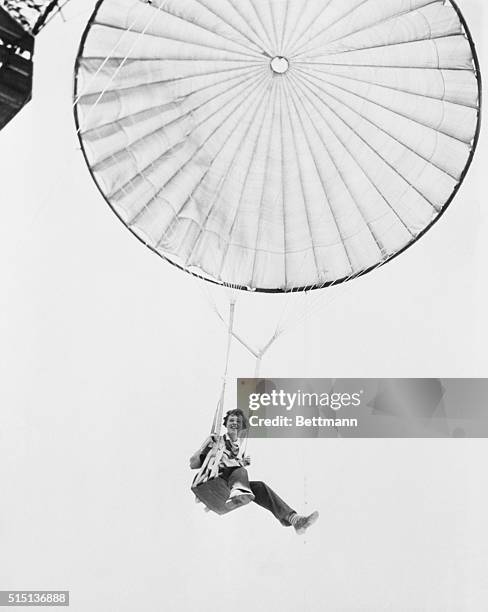 Amelia Earhart Tests Captive Parachute. At Prospertown, N.J., Amelia Earhart helped test a commercial parachute training device that appeared to have...