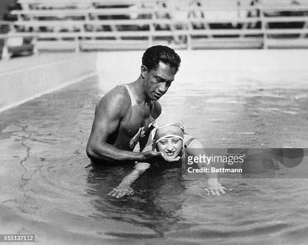 Duke Khanamokuis teaching Estelle Taylor, wife of Jack Demsey, how to swim at the Ambassador Hotel Plunge.