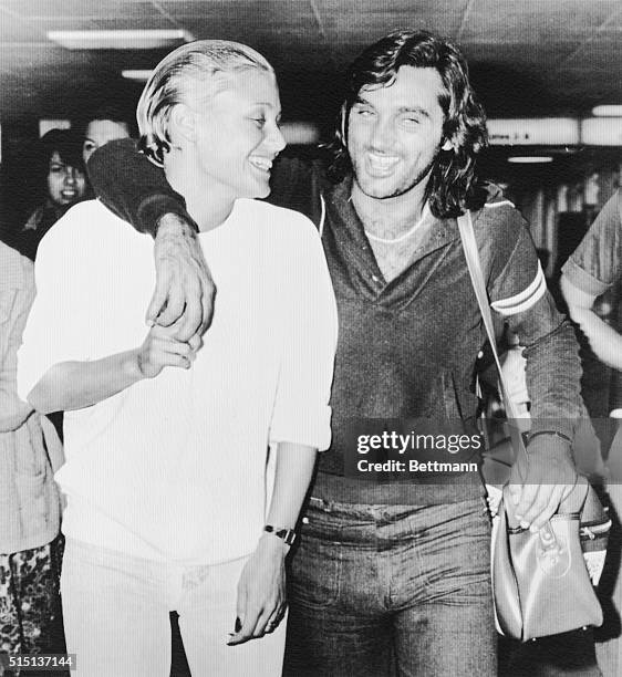 Soccer star George Best and his girlfriend, Angela MacDonald-Janes seem to be very happy as they arrive at Heathrow Airport 8/21 on a flight from Los...