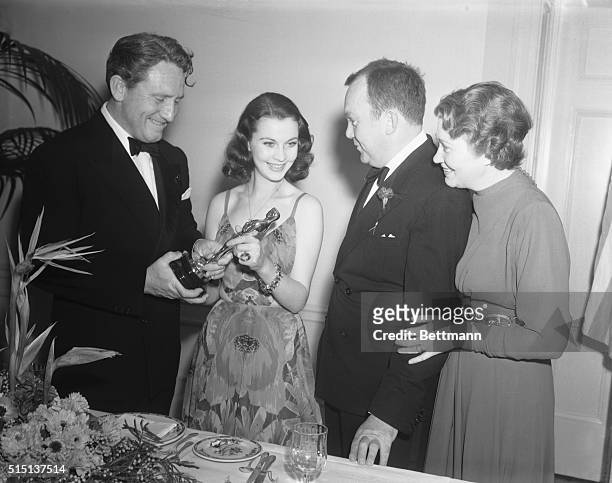 Old and New Winners at Academy Awards Banquet. Los Angeles, Calif.: Congratulations from 1938 winners are extended to 1939 recipients of awards for...