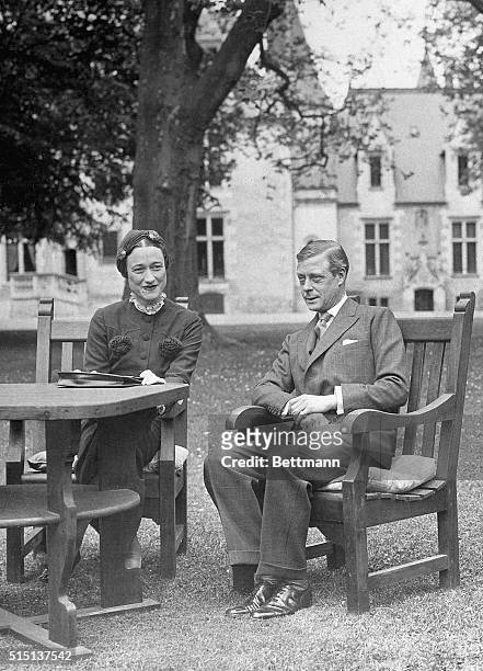France: Edward VIII, Duke of Windsor, sits with his wife Wallis Simpson at the Chateau de Cands in France. Photo shows a full length view of the...