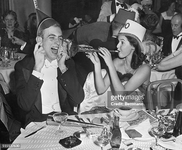 New York, New York- William Van Nostrand and Josephine Johnson, whoop it up as they celebrate the arrival of the New Year in the Sert Room of the...