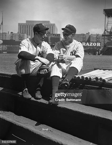Joe DiMaggio, left, star rookie of the Yankees in 1936, poses with the 1937 recruit who is filling his shoes as the stellar attraction of 1937, Tom...