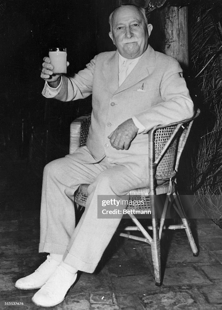 John Harvey Kellogg Sitting and Holding Glass