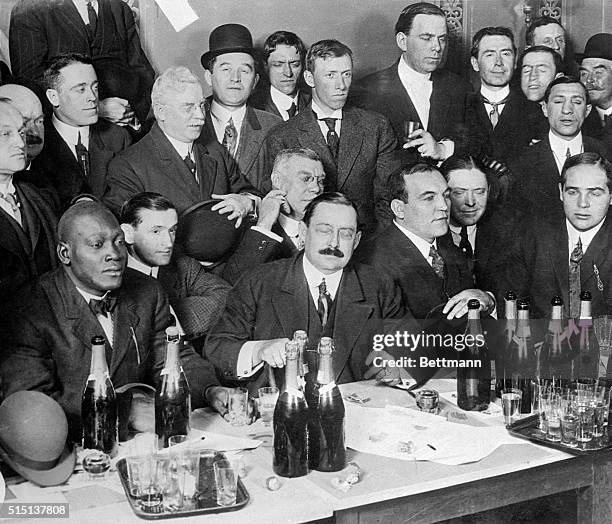 Left to right, seated, Johnson, Hype Igoe, Geo. Little. Behind Little sits Honest John Kelly and behind Kelly is cartoonist Tad. Jeffries 4th from...