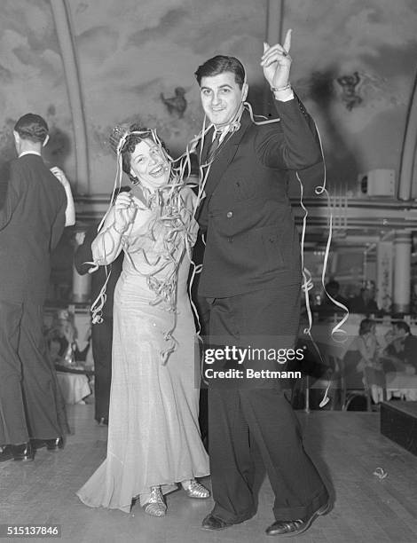 Infant 1938 gets a taste of the Big Apple. Mr. And Mrs. Joseph Giambrone welcome the the New Year by doing the "Big Apple" at the Cotton Club, New...