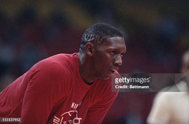 Sporting a haircut with his school's initials, University of Nevada-Las Vegas center, David Butler, rests during practice for the NCAA Western...