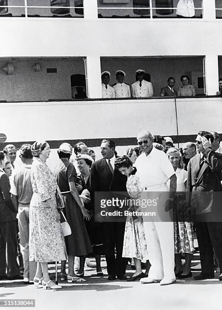 King Paul of Greece is shown with some of his royal guests on the dock just before the SS Agamemnon left Naples on the ‘Cruise of Kings.' Guests were...