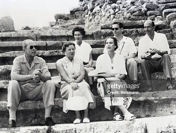 Posing at the Delphi Amphitheatre during the Royal cruise, guided by the King and Queen of Greece, are host and hostess and four of the guests. In...