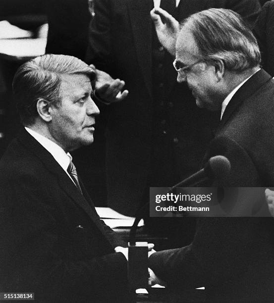 Bonn, West Germany: Helmut Schmidt, right, who was defeated in a no-confidence vote by Kohl, congratulates the new West German chancellor, Helmut...
