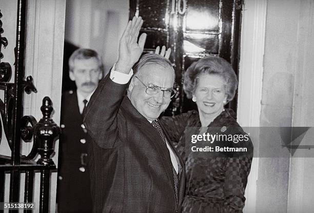 London, England: West German chancellor Helmut Kohl waves as he is greeted at 10 Downing Street by P.M. Margaret Thatcher. This is Herr Kohl's first...