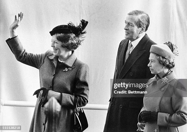 London: H. M. Queen Beatrix of the Netherlands waves to the waiting crowds on her arrival with prince Claus 11/16, at Westminster Pier, London where...