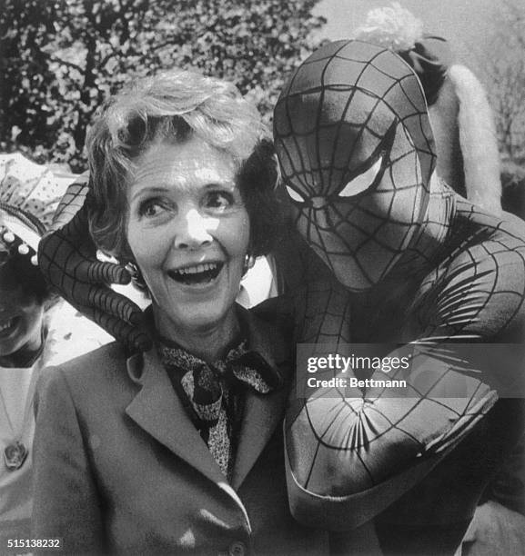 Washington: Nancy Reagan gets tangled up with Spiderman during the festivities at the 1982 White House Easter Egg Roll 4/12 on the South Lawn.