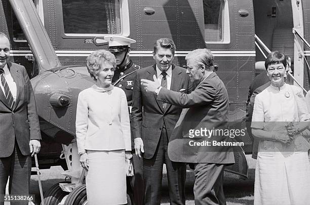 Bonn, West Germany: Chancellor Helmut Schmidt greets President Ronald Reagan as he arrives at the chancellery to attend the NATO summit and visit...