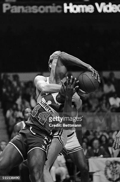 Washington Bullets' Rick Mahorn and Celtics' Larry Bird engage in a wrestling match for the ball during 1st quarter action at Boston Garden, 3/31....