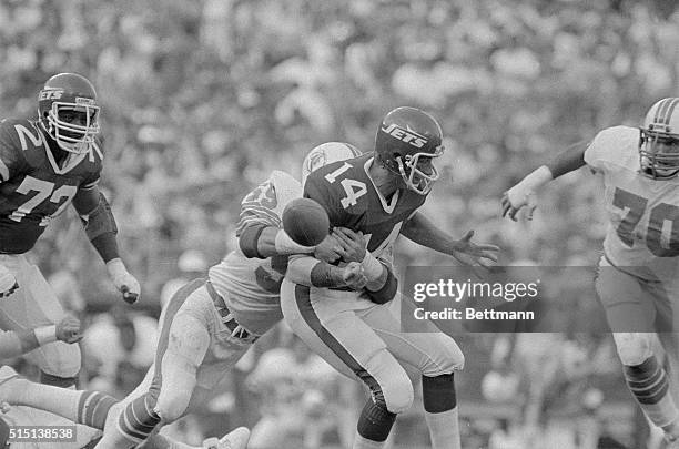 Jet's quarterback Richard Todd fumbles after being hit by Dolphin's Bob Brudzinski in the second quarter of the game in this photo. The Dolphins...