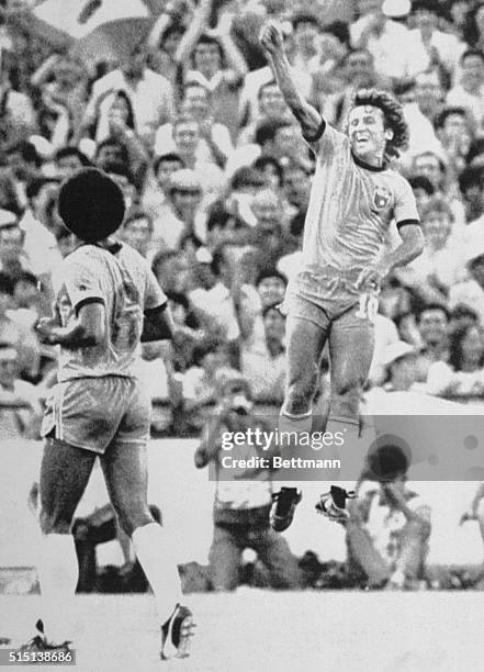 Seville, Spain: Zico jumps in joy after scoring Brazil's first goal in World cup match vs New Zealand 6/23. At left is Brazil's Junior.