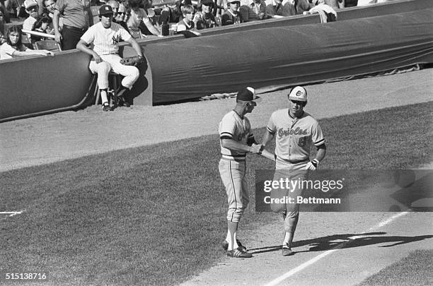 Proud Father and Son. New York: Baltimore Orioles 3rd base coach Cal Ripken Sr. Gives his son Cal Ripken Jr. A hand shake and a pat on the back as...