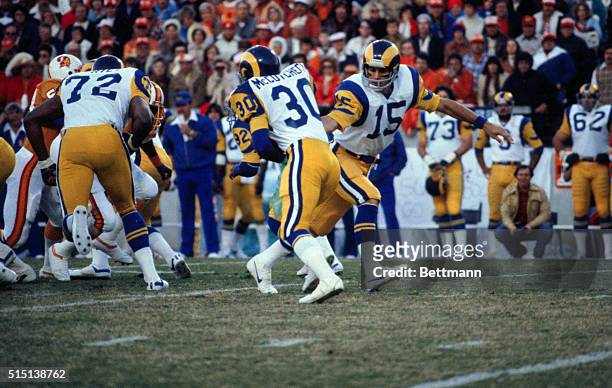 Vince Ferragamo , quarterback for the L.A. Rams, passing off ball to Lawrence McCutcheon during the AFC Championship game against the Tampa Bay...