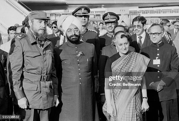 Fidel Castro , president of Cuba, poses for photographers at the New Delhi airport March 6 with India's president Zail Singh and prime minister Mrs....