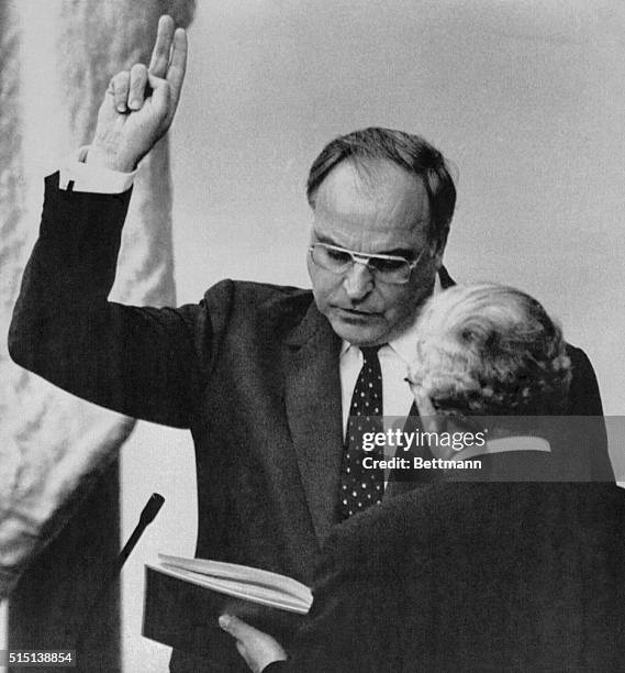 Bonn, West Germany: West German chancellor Helmut Kohl takes oath of office from Bundestag President Rainer Barzel after reelection by the West...