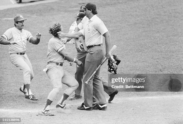 Royals' George Brett is finally collared by umpire Joe Brinkman after he was ruled out for using an improper bat, nullifying a ninth inning, two run...