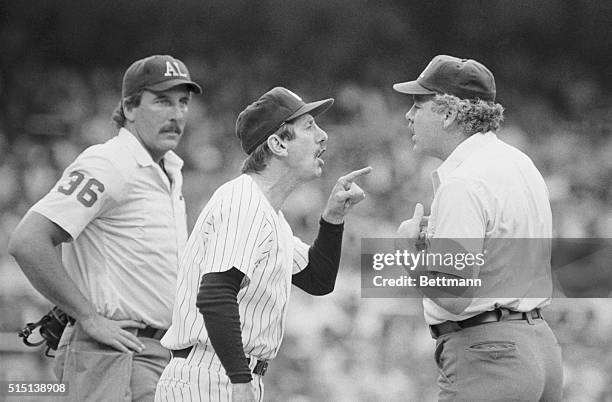 New York Yankees manager Billy Martin is shown arguing with umpire Tim McClelland over the amount of pine tar on the bat used by George Brett of the...