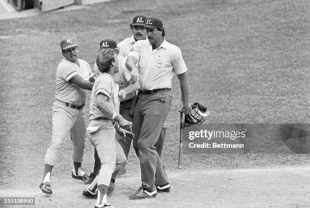 Royals' George Brett charges at umpire Tim McClelland who is holding his bat, after the umpires ruled the bat illegal nullifying his two-run homer in...