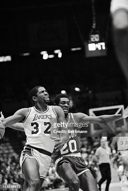 Houston Rockets guard Terry Teagle looks frantic as Los Angeles Lakers guard Magic Johnson drives to the basket for a lay up in the 1st period of the...