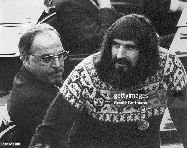 Bonn, West Germany: West German chancellor Helmut Kohl, named the "Black Giant" for his height, looks at an even taller member of Parliament, Walter...