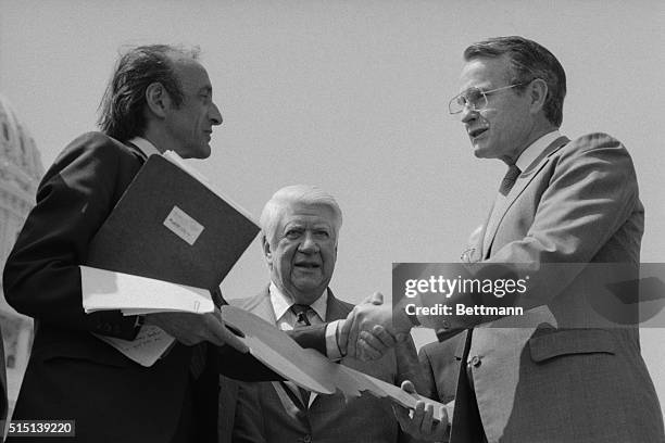 Washington, D.C.: Vice President George Bush presents Elie Wiesel, chairman of the Holocaust Memorial Museum Council a symbolic key to two surplus...