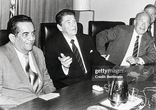 San Pedro Sula, Honduras: President Reagan meets with Honduras President Roberto Suazo Cordova as U.S. Secretary of State George Shultz looks on ....