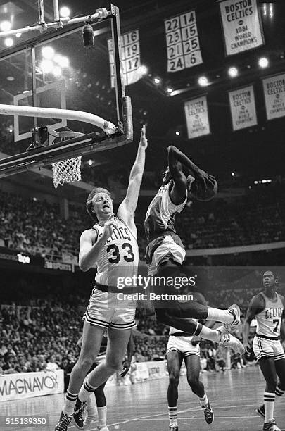 Celtics' Larry Bird attempts to block high flying Atlanta Hawks' Dominique Wilkins who goes up for a slam dunk during 3rd quarter action in game one...