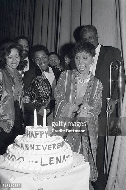 Lena Horne is delighted as she cuts her cake 5/12 backstage at the Warner Theatre. Lena, along with members of the cast, celebrated her show as the...