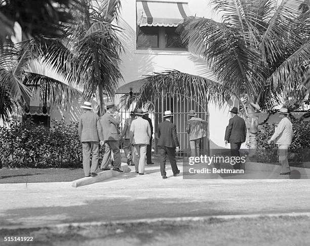 Photo shows men from the Sheriff's Department of Dade County, entering Al Capone's home at Miami Beach, Florida, for a raid.