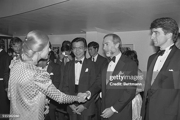 The Duchess of Kent shakes hands with New York Times correspondent Sydney Schanberg on her arrival for the Royal European Charity Premiere of The...