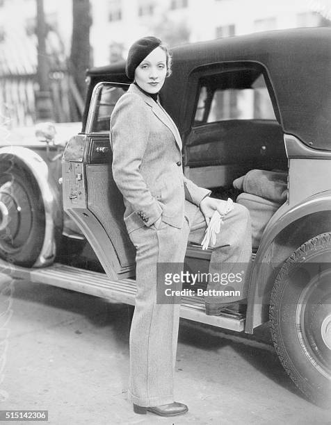 Wearing a beret and carrying gloves, Marlene Dietrich, prominent Paramount screen star, jauntily strolls along Hollywood Street attired in a grey...