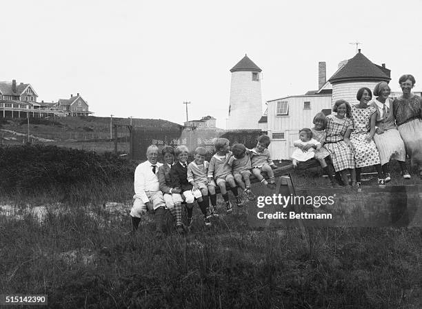 The Gilbreth family sits atop a see-saw while they spend their 1923 summer in an old lighthouse on Nantucket Island. From left to right are Major...