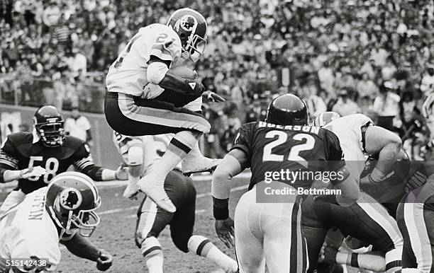 Washington: Washington Redskins' Mike Nelms leaps on a kickoff return in the third period as Bears Dave Duerson moves in for the tackle.