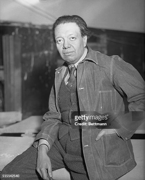 Diego Rivera, famous Mexican Artist, seen at work on the mural decorations of frescoes, he is painting in the Great Hall of the 70-story RCA Building...