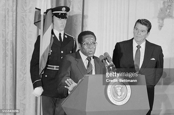 Washington, D.C.: Zimbabwe Prime Minister Robert G. Mugabe tells a news conference that he and President Reagan, looking on, have generally agreed on...