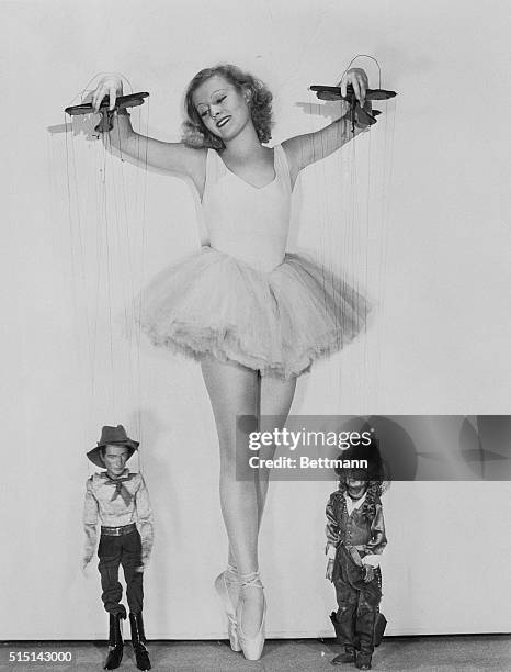 Actress Lillian Harvey dressed as a ballet dancer holding puppets in 1933. Harvey's most successful film was Der Knogress Tanzt in 1931 which led to...