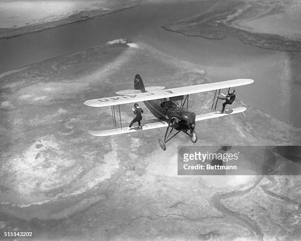 Billy Bomar and Uva Kimmey of the Howard Flying Circus are just out for a stroll, doing a little wing-walking on the Waco plane in flight over Barren...