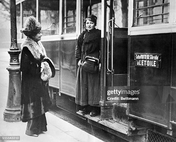 Paris, France- Mrs. E. Pankhurst, the British Militant Suffragette, is shown in Paris talking to one of the women street car conductors. Since the...