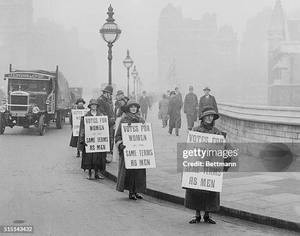 Group of suffragists picket outside the House of Commons. Presently, a bill is being passed giving women the right to vote at the age of 21.