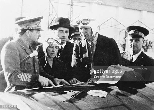 Lindberghs Receive Guidance from General Balbo. Tripoli, Libya: General Italo Balbo, left, governor general of Libya, is shown as he gave...