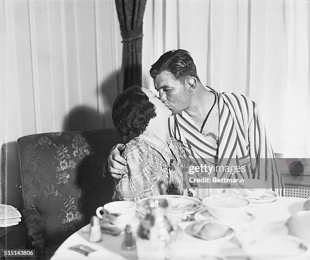 Mrs. James Braddock gives the final congratulations in the form of a big kiss to husband Jimmy Braddock, at their suite in the Mayflower hotel, New...