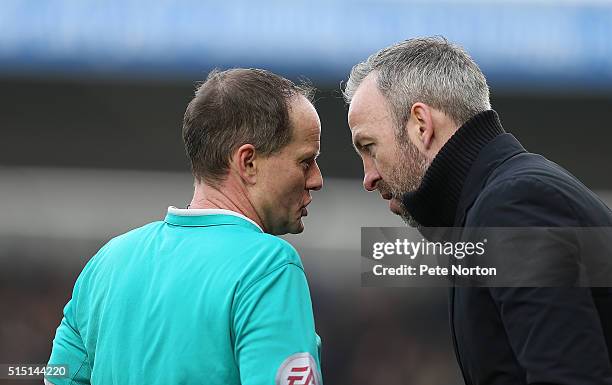 Referee Rob Lewis makes a point to Cambridge United manager Shaun Derry during the Sky Bet League Two match between Northampton Town and Cambridge...
