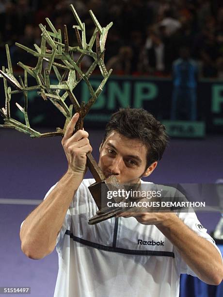 French STbastien Grosjean kisses his first place trophy after winning the final game against his Russian opponent Yevgeny Kafelnikov on the seventh...