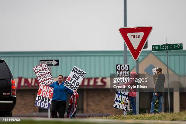Members of the Westboro Baptist Church protest before a campaign rally at the Adams Mark Hotel for Republican presidential candidate, Sen. Ted Cruz...